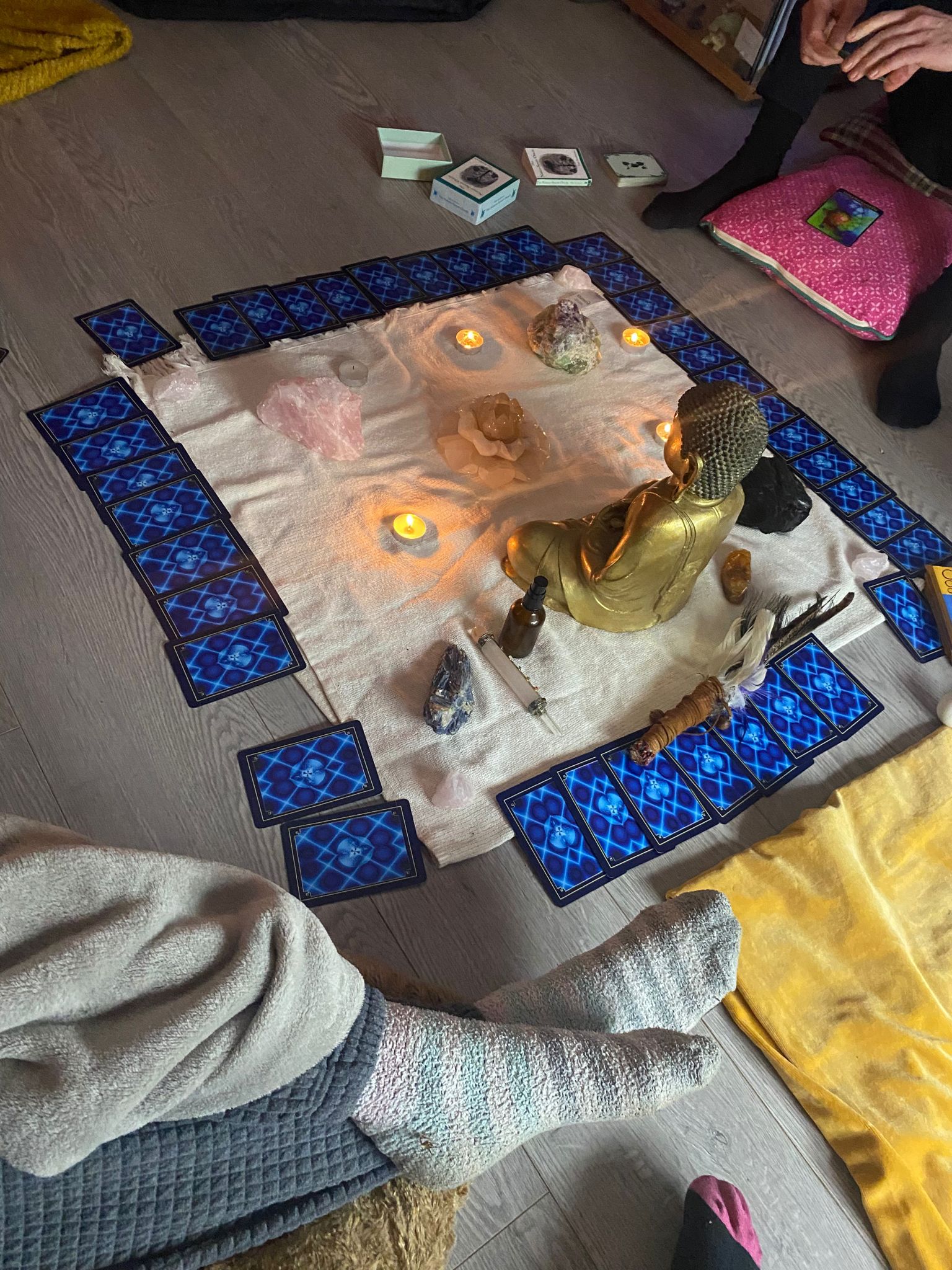 Cards, crystals and candlelight arranged in a circle in the session room